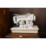 A NEW HOME 'TRIPLE ZIG ZAG' MODEL No. 888 ELECTRIC SEWING MACHINE, IN HARD PLASTIC CASE