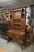 A GEORGE III OAK DRESSER OF SMALL PROPORTIONS AND WITH MAHOGANY CROSSBANDING, THE BASE HAVING TWO