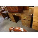 A LATE TWENTIETH CENTURY OAK KNEEHOLE DESK