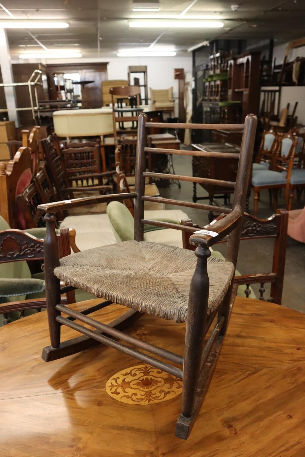 A CHILD'S RUSH SEATED ROCKING CHAIR