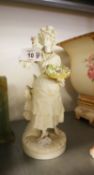 A CONTINENTAL WHITE PARIAN FIGURE OF A WOMAN FLOWER SELLER, ON CIRCULAR BASE, 9 ½” HIGH (HEAD AND