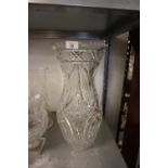 A LARGE AND HEAVILY FLORAL AND FOLIATE CUT GLASS BALUSTER FLOWER VASE WITH SERRATED RIM, 16 ½”