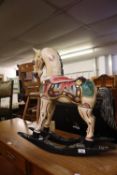 A PAINTED WOODEN MODEL ROCKING HORSE
