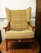 A 1960's WOODEN FRAMED EASY ARMCHAIR WITH ORIGINAL FABRIC