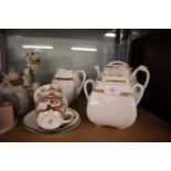 A WHITE GLAZED GILT HANDLED 3 PIECE TEA SET, COMPRISING; TEAPOT, SUGAR BASIN, CREAM JUG AND TWO