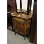 AN OAK OCTAGONAL SHAPED GILBERT GRAMOPHONE, HAVING LIFT-UP LID AND TWO CUPBOARD DOORS (A.F.) (