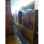 A YEW WOOD THREE PART FLOOR STANDING WALL UNIT, THE CENTRAL SECTION HAVING OPEN ARCH TOP DISPLAY