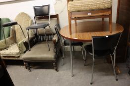 A TUBULAR FRAMED CIRCULAR TOPPED DINING TABLE AND THREE BLACK LEATHERETTE CHAIRS (4)