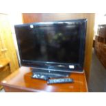 WHARFDALE 26” FLAT SCREEN TELEVISION, A SAGECOM FREESAT BOX AND A SONY VIDEO/DVD PLAYER, IN A YEW