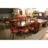A MAHOGANY REPRODUCTION TWIN PEDESTAL DINING TABLE WITH ADDITIONAL LEAF AND A SET OF EIGHT GOOD