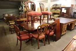 A MAHOGANY REPRODUCTION TWIN PEDESTAL DINING TABLE WITH ADDITIONAL LEAF AND A SET OF EIGHT GOOD