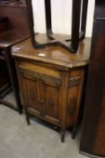 AN OAK OCTAGONAL SHAPED GILBERT WIND-UP GRAMOPHONE, HAVING LIFT-UP LID AND TWO CUPBOARD DOORS (A.F.)