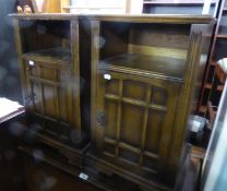 A PAIR OF OAK BEDSIDE CUPBOARDS, HAVING AN OPEN SECTION OVER A PANEL DOOR (2)
