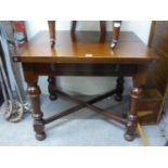 A MAHOGANY DINING TABLE WITH SWIVEL AND FLAP TOP, RAISED ON TURNED SUPPORTS