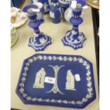 A WEDGWOOD DARK BLUE JASPERWARE OBLONG TRAY AND A PAIR OF SIMILAR CANDLESTICKS (3)