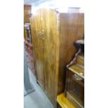 A 1930's FIGURED WALNUTWOOD GENTS TWO DOOR WARDROBE