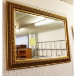 A BEVELLED EDGE GILT FRAME RECTANGULAR WALL MIRROR 65cm HIGH X 96cm WIDE