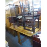 AN OAK SAVE-SPACE DINING TABLE AND FOUR LADDER BACK DINING CHAIRS (5)