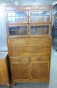 AN OAK BUREAU BOOKCASE WITH TWO SECTIONAL STACKING BOOKCASES SURMOUNTING THE UPRIGHT FALL-FRONT,
