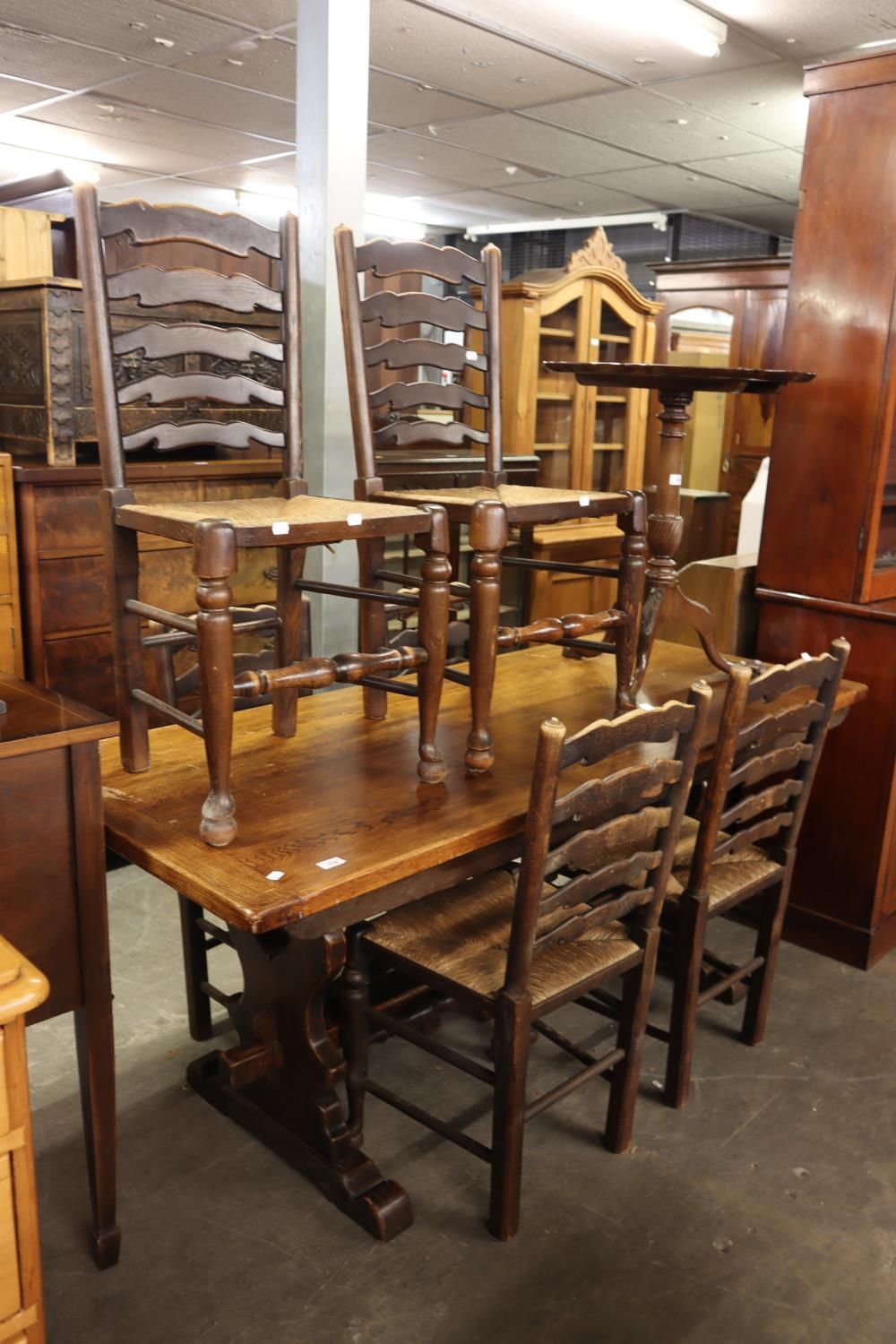 OAK REFECTORY DINING TABLE, ON TRESTLE END SUPPORTS AND A SET OF SIX OAK LADDER BACK DINING CHAIRS