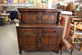A DARK STAINED ERCOL COURT CUPBOARD