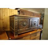 A 1930's OAK BLANKET BOX, HAVING CARVED DETAIL