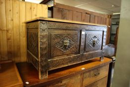 A 1930's OAK BLANKET BOX, HAVING CARVED DETAIL