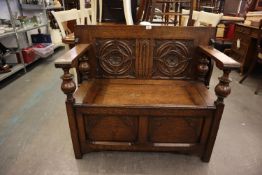 ENGLISH GOTHIC OAK MONKS BENCH, THE LIFT-UP TOP/BACK HAVING TWO CARVED PANELS AND THE BASE HAVING