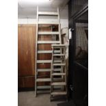 A SET OF VINTAGE EXTENDING WOODEN LADDERS AND TWO PAIRS OF VINTAGE WOODEN STEP LADDERS (3)