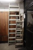 A SET OF VINTAGE EXTENDING WOODEN LADDERS AND TWO PAIRS OF VINTAGE WOODEN STEP LADDERS (3)