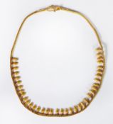 MIDDLE EASTERN GOLD COLOURED METAL ROPE CHAIN NECKLACE, with a fringe of 37 boteh shaped drops,