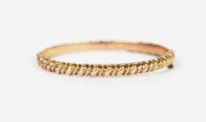 VICTORIAN 9ct GOLD HINGE OPENING HOLLOW BANGLE, heavily spirally lobed with bead and bar decoration,