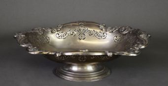 GEORGE V EMBOSSED AND PIERCED SILVER PEDESTAL DISH, of oval form with wavy floral border above