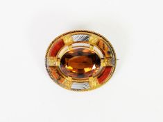 VICTORIAN GOLD COLOURED METAL BROOCH set with a large oval pink topaz in a chased frame set with six
