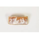 CURVED OBLONG SHELL CAMEO BROOCH, well-carved wtih a winged cherub and two female figures in the