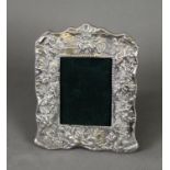 EMBOSSED SILVER FRONTED DESK OR DRESSING TABLE TOP PHOTOGRAPH FRAME, of shaped oblong from with