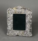 EMBOSSED SILVER FRONTED DESK OR DRESSING TABLE TOP PHOTOGRAPH FRAME, of shaped oblong from with