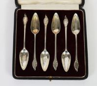 SET OF SIX SILVER NARROW BOWLED GRAPEFRUIT SPOONS, the handles with thread border, rococo embossed