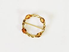 GOLD COLOURED METAL CHAIN PATTERN CIRCLET BROOCH, claw set with four oval citrines, 1 1/8in (3cm)