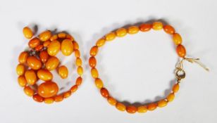 BUTTERSCOTCH AMBER NECKLACE OF GRADUATED OVAL BEADS, with ring clasp, 25in (64cm) plus five larged