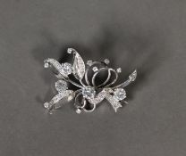 WHITE GOLD AND DIAMOND FLORAL AND FOLIATE SPRAY BROOCH, the four principal round brilliant cut