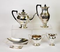 FOUR PIECE ELECTROPLATED PEDESTAL TEA SET, of oval part panelled form with black angular scroll