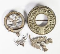 TWO SILVER COLOURED METAL SCOTTISH BROOCHES, one as a stag's head, the other thistles; two larger