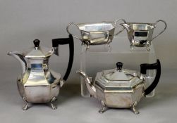 FOUR PIECE ELECTROPLATE TEA SET, of canted oblong form with black angular scroll handles and