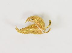 ITALIAN 18K GOLD DOUBLE LEAF SPRAY BROOCH, tied with a ribbon set with three small diamonds, 1 3/4in