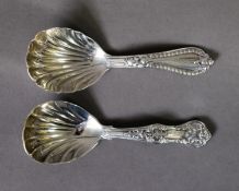 TWO VICTORIAN SLIVER CADDY SPOONS WITH SHELL PATTERN BOWLS AND FANCY HANDLES, comprising, a Queens