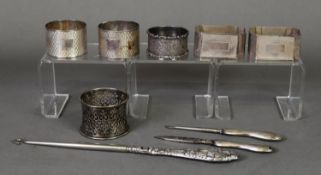 TWO BOXED PAIRS OF ENGINE TURNED SILVER NAPKIN RINGS, one pair round, Sheffield 1937, the other pair