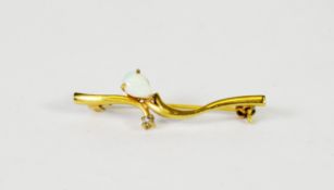 GOLD PLATED SCROLLED BAR BROOCH, the cross-over center set with an opal and a tiny white stone and a