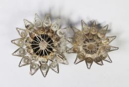 TWO MIDDLE EASTERN FILIGREE SILVER STAR SHAPED BROOCHES, each with an enamelled high domed centre (