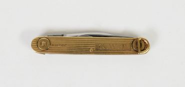 9ct GOLD CASED PENKNIFE with a folding bale at each end, engine turned decoration, initialled G.W.